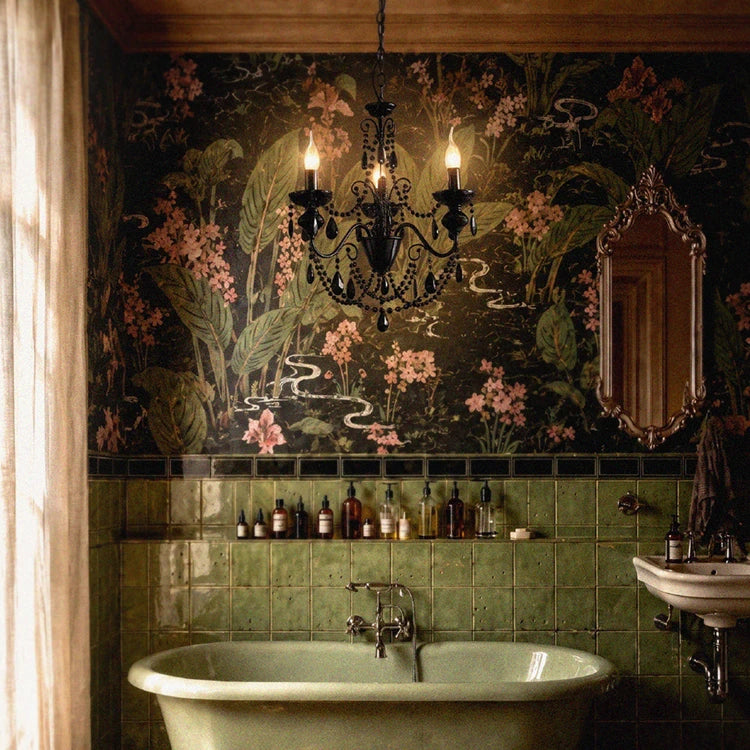 A chandelier above a freestanding bath and botanical wallpaper