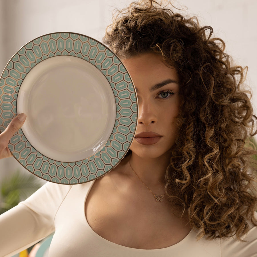 A model holding up an Ozarke's Tiffany Blue Plate set